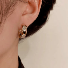 Model showcasing the dangle and style of the 14K Gold-Plated Zircon Gourd Hoop Earrings