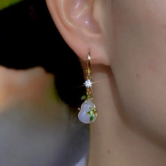 Model showcasing the dangle and style of the 14K Gold-Plated Zircon Green Bamboo Gourd Earrings