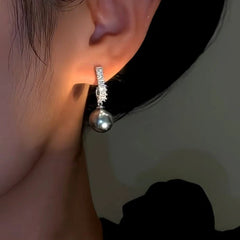 Angled view of the 14K Gold-Plated Zircon Grey Pearl Earrings