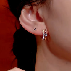Model showcasing the dangle and style of the 14K Gold-Plated Zircon Heart Hoop Earrings