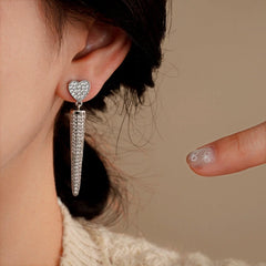Angled view of the 14K Gold-Plated Zircon Heart Tassel Earrings