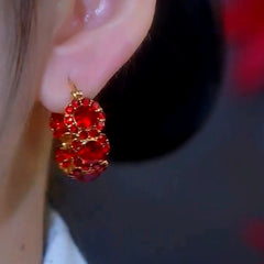 Model showcasing the dangle and style of the 14K Gold-Plated Zircon Hoop Earrings