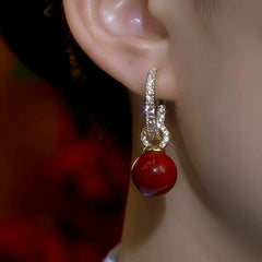 Model showcasing the dangle and style of the 14K Gold-Plated Zircon Hoop Pearl Earrings