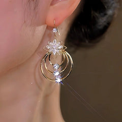 Model showcasing the dangle and style of the 14K Gold-Plated Zircon Ice Flower Ear Hook Earrings