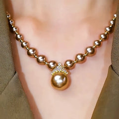 14K Gold-Plated Zircon Inlaid Champagne Pearl Necklace worn to showcase its length and pendant detail