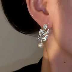 Model showcasing the dangle and style of the 14K Gold-Plated Zircon Leaf Bead Earrings