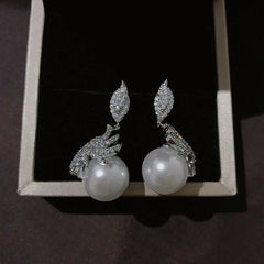 Angled view of the 14K Gold-Plated Zircon Leaf Pearl Earrings