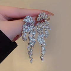 Angled view of the 14K Gold-Plated Zircon Leaf Tassel Earrings