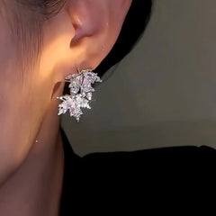 Model showcasing the dangle and style of the 14K Gold-Plated Zircon Maple Leaf Earrings