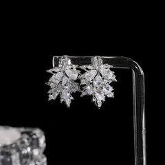 Angled view of the 14K Gold-Plated Zircon Maple Leaf Earrings