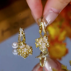Angled view of the 14K Gold-Plated Zircon Maple Leaf Pearl Earrings