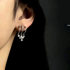 Model showcasing the dangle and style of the 14K Gold-Plated Zircon Multi-Layer Cross Tassel Earrings
