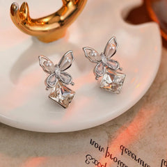 Model showcasing the dangle and style of the 14K Gold-Plated Zircon Pearl Butterfly Zircon Cube Earrings