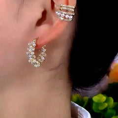 Model showcasing the dangle and style of the 14K Gold-Plated Zircon Pearl Hoop Earrings