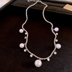 Detailed view of the 14K Gold-Plated Zircon Pearl Tassel Necklace chain and pendant