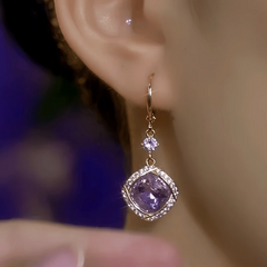 Model showcasing the dangle and style of the 14K Gold-Plated Zircon Purple Diamond Tassel Earrings