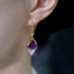 Women's gold purple rose gem crystal drop dangle earring worn on left ear