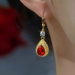 Angled view of the 14K Gold-Plated Zircon Red Crystal Drop Earrings
