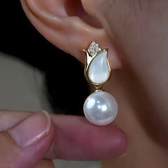 Model showcasing the dangle and style of the 14K Gold-Plated Zircon Rose Pearl Earrings