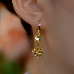 Model showcasing the dangle and style of the 14K Gold-Plated Zircon Round Drop Earrings