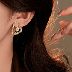Model showcasing the dangle and style of the 14K Gold-Plated Zircon Snake Heart Stud Earrings