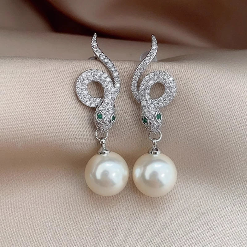 Angled view of the 14K Gold-Plated Zircon Snake Pearl Earrings