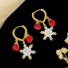 Angled view of the 14K Gold-Plated Zircon Snowflake Tassel Earrings