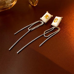 Model showcasing the dangle and style of the 14K Gold-Plated Zircon Square Tassel Earrings