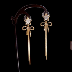 Angled view of the 14K Gold-Plated Zircon Star Bow Tassel Earrings