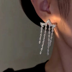 Model showcasing the dangle and style of the 14K Gold-Plated Zircon Star Tassel Earrings
