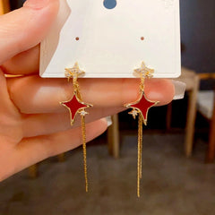 Angled view of the 14K Gold-Plated Zircon Star Tassel Earrings