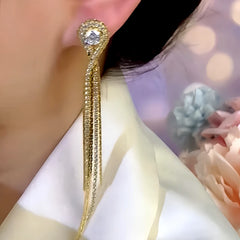 Model showcasing the dangle and style of the 14K Gold-Plated Zircon Tassel Earrings