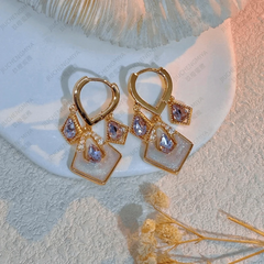 Model showcasing the dangle and style of the 14K Gold-Plated Zircon Tassel Earrings