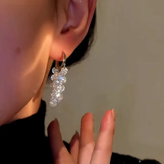 Model showcasing the dangle and style of the 14K Gold-Plated  Zircon Tassel Earrings