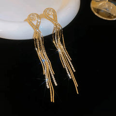 Angled view of the 14K Gold-Plated Zircon Tassel Earrings