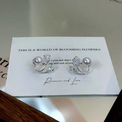 Model showcasing the dangle and style of the 14K Gold-Plated Zircon Tulip Flower Pearl Jacket Earrings