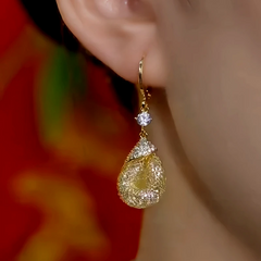 Model showcasing the dangle and style of the 14K Gold-Plated Zircon Water Drop Earrings