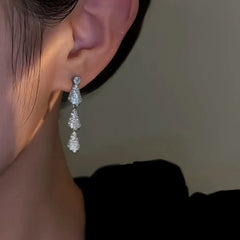 Model showcasing the dangle and style of the 14K Gold-Plated Zircon Water Drop Earrings