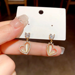 Close-up detail of the sparkling zircons and plating on the Cat's Eye Heart Earrings