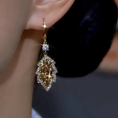 Close-up detail of the sparkling zircons and plating on the gold leaf earrings