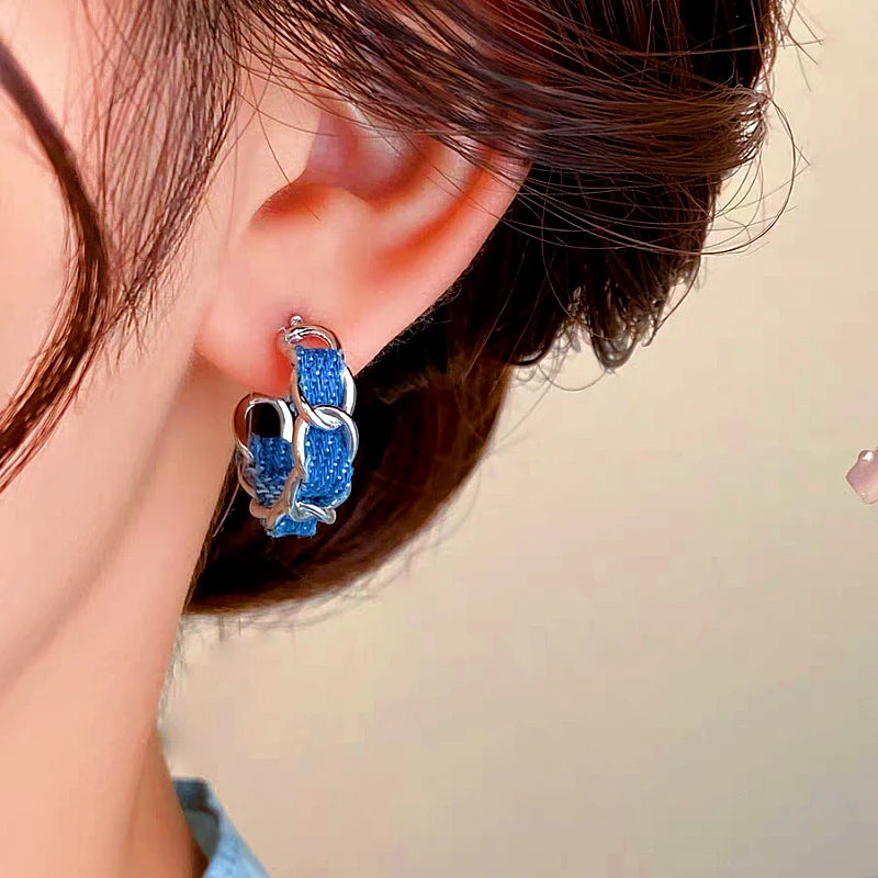 Model showcasing the dangle and style of the 14K Gold-plated Blue C-Shaped Earrings