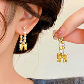 Gold Pearl Bow Drop Earrings for Women - Worn & Handheld Closeup