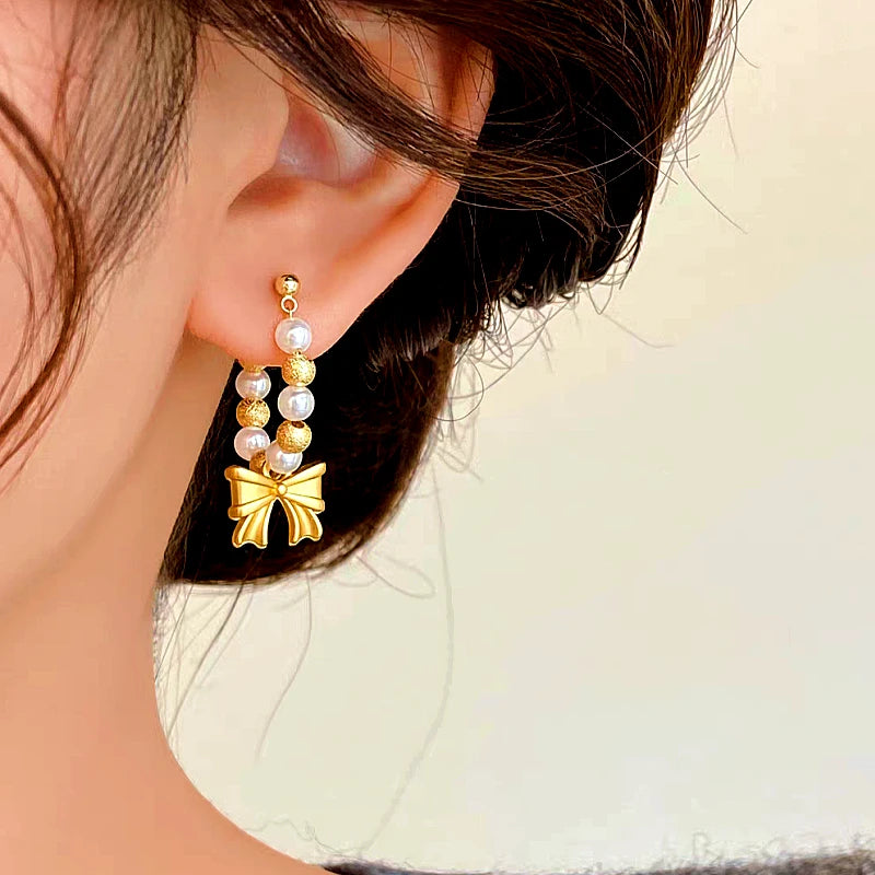 Close-up detail of the sparkling zircons and plating on the Beaded Bow Earrings