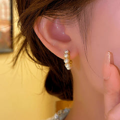 Angled view of the 14K Gold-plated C-Shaped Bead Earrings