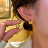 Gold Camellia Flower Stud Earrings, Hand Holding One Next to Worn Ear