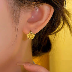 Model showcasing the dangle and style of the 14K Gold-plated Camellia Small Hoop Earrings
