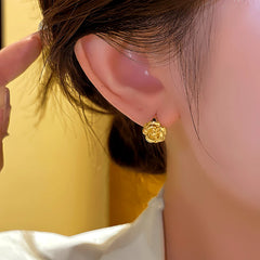 Close-up detail of the sparkling zircons and plating on the Camellia Hoop Earrings