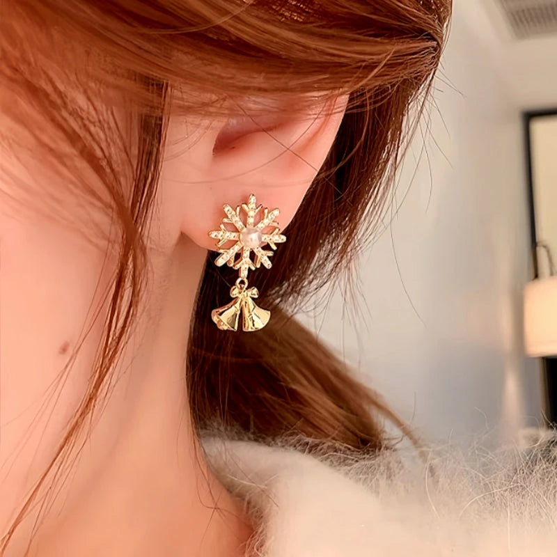 Model showcasing the dangle and style of the 14K Gold-plated Christmas Diamond Snowflake Bell Earrings
