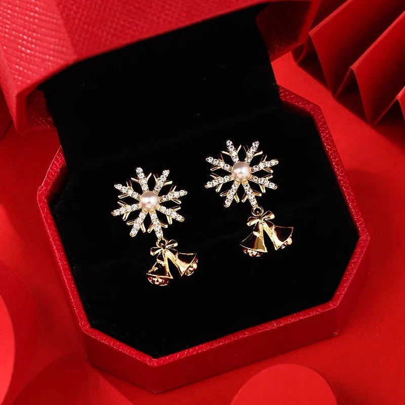 Angled view of the 14K Gold-plated Christmas Diamond Snowflake Bell Earrings