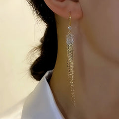 Model showcasing the dangle and style of the 14K Gold-plated Diamond-Studded Wheat Tassel Earrings